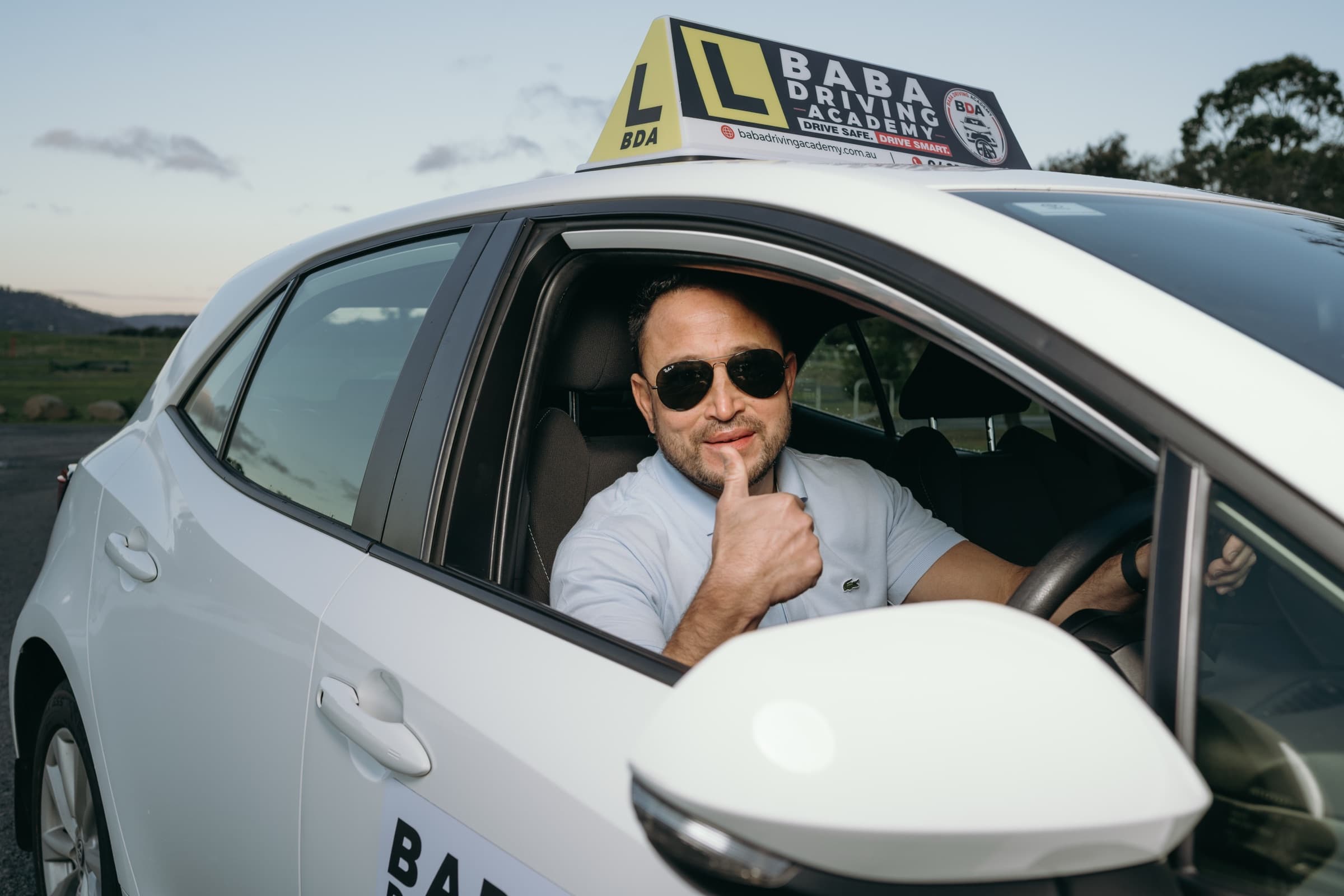 Instructor Indra Khadka in the driver's seat of the training car